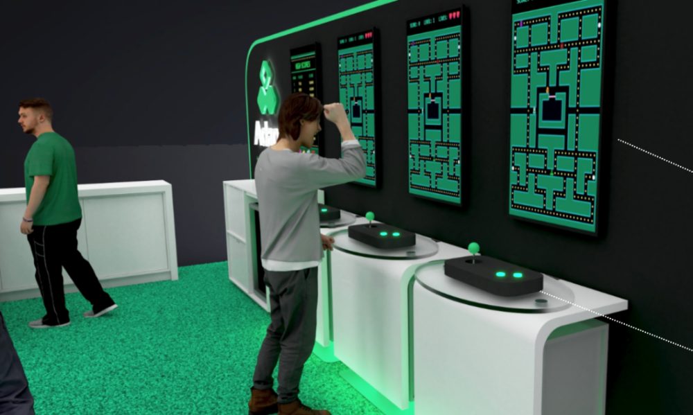 Adapt booth 517 — green branded counter and arcade stations